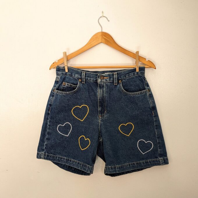 A pair of Embroidered Heart Shorts.