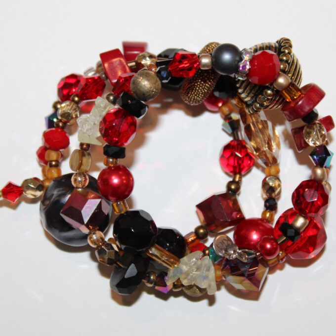 a close up of a large red bracelet .