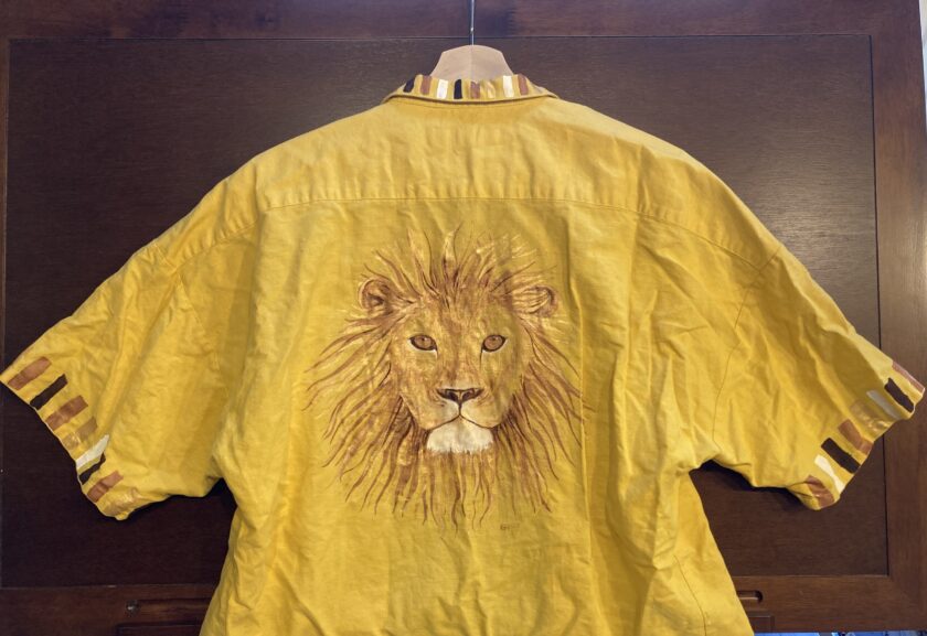 a yellow shirt with a picture of a lion on it.