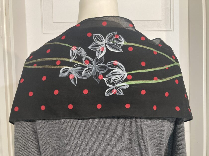 a black jacket with red and white flowers on it.