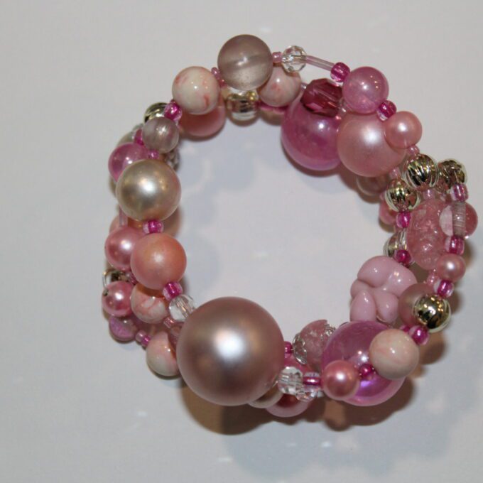 pink bracelet bracelet on a table.