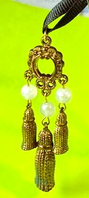 Unusual three drop gold tone pendent with three opaque white plastic beads