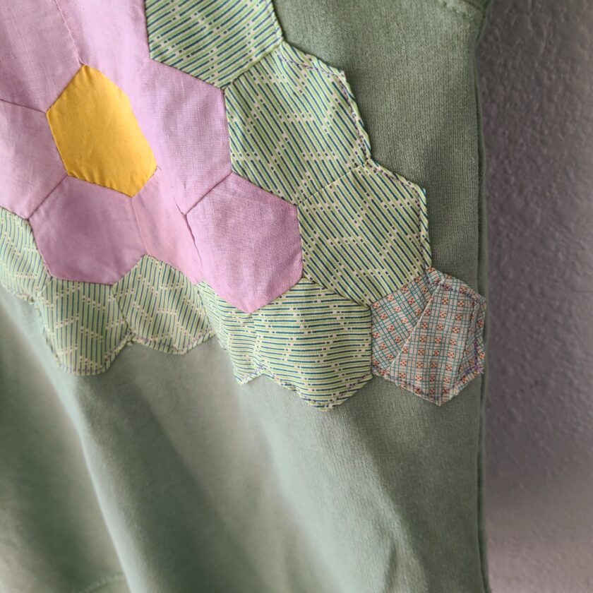 a close up of a shirt with a patchwork design on it.