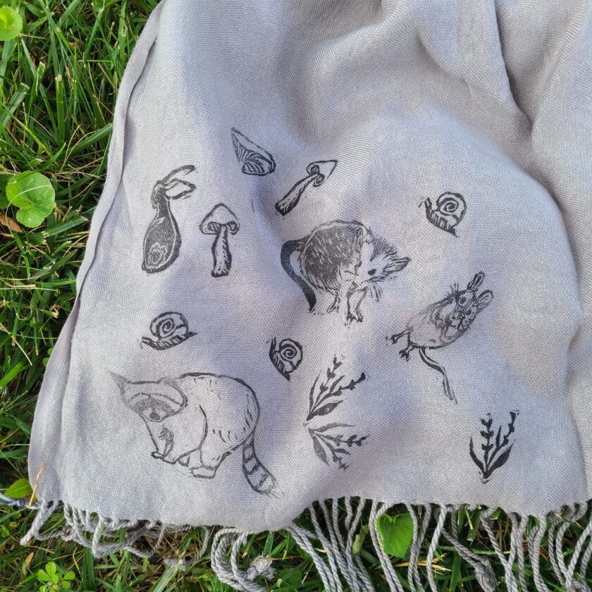 a scarf with a picture of animals on it.