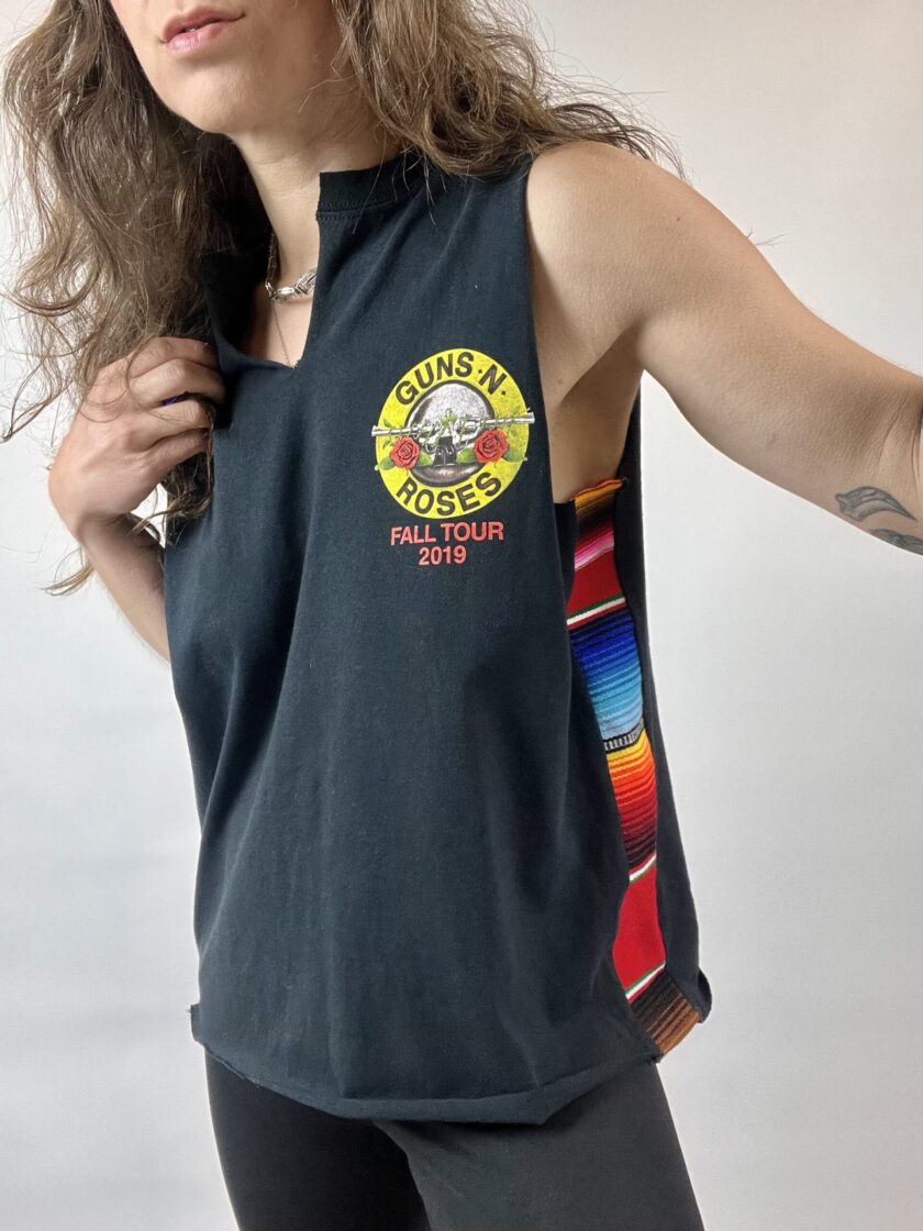 a woman with long hair wearing a black tank top.