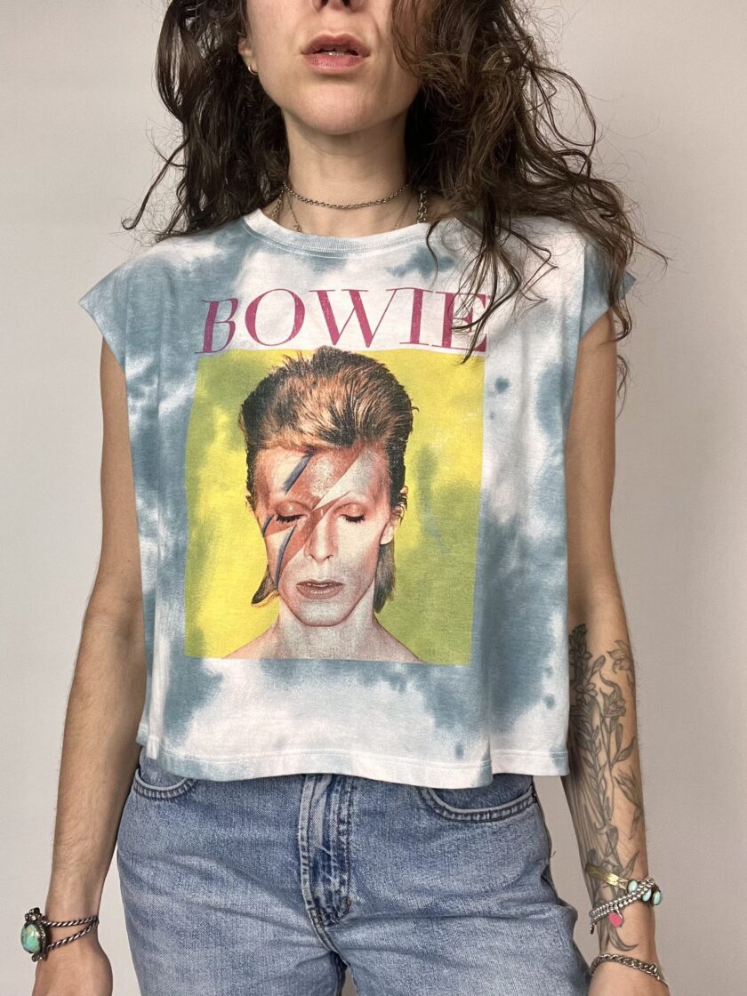 a woman wearing a shirt with a picture of david beck on it.