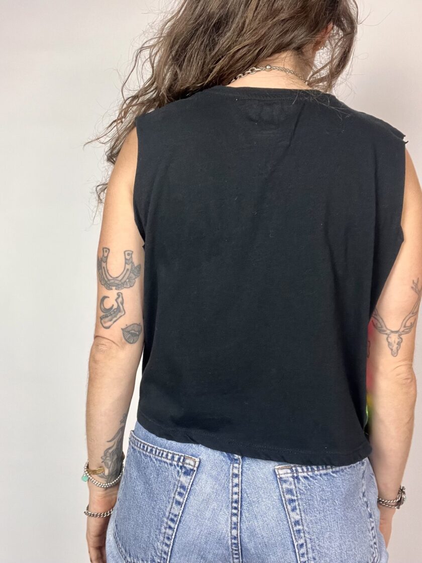 a woman with tattoos on her arms and back.
