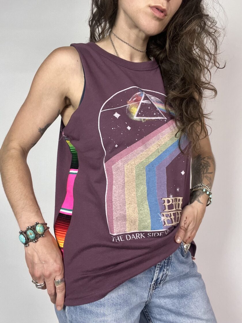 a woman with long hair wearing a tank top.