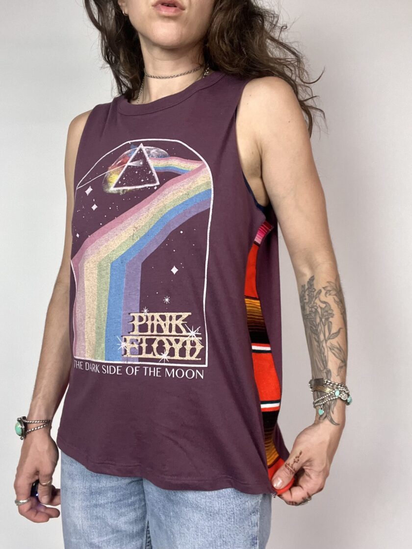 a man with long hair wearing a tank top.