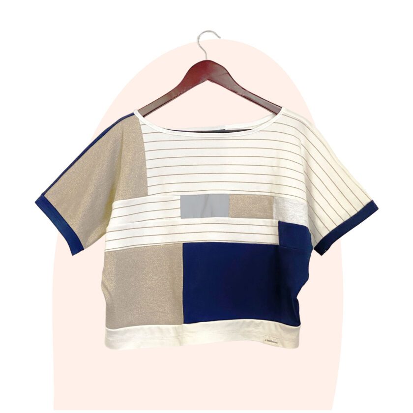 A gold, blue and white drapey t-shirt top
