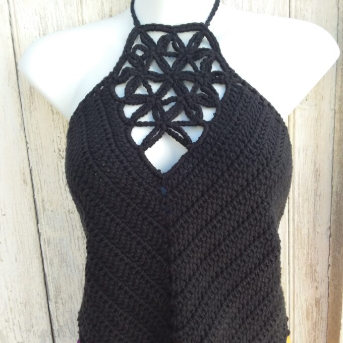 a black crochet crop top halter on a mannequin.
