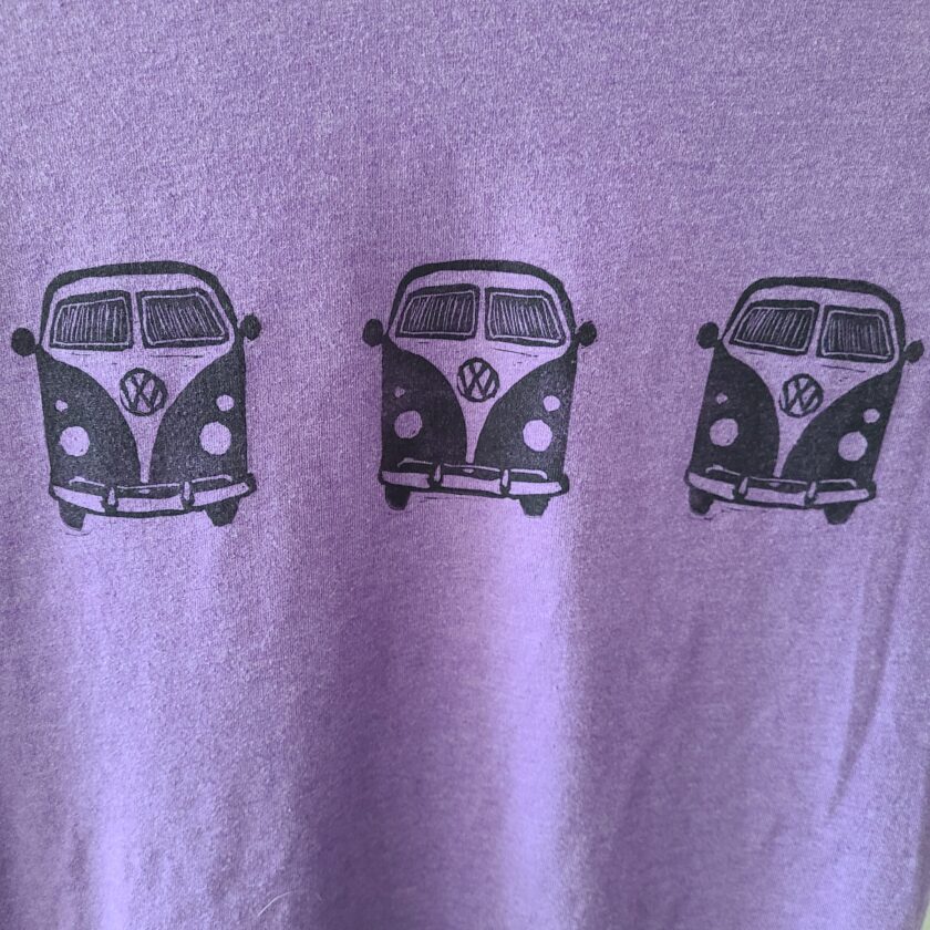 a purple t - shirt with three vw vans on it.