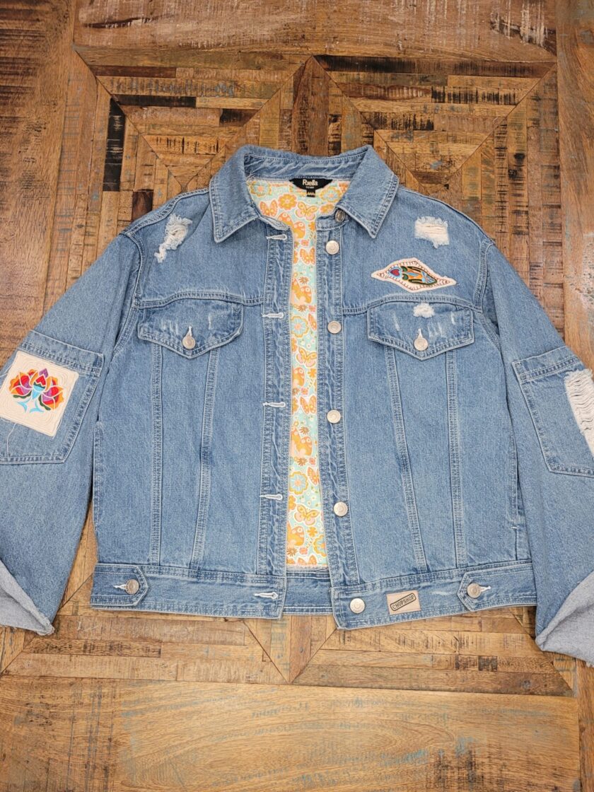 a denim jacket with patches on it.