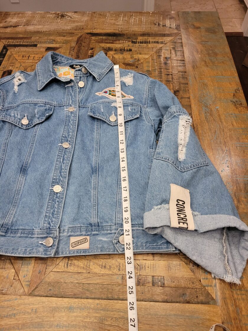 a denim jacket with a measuring tape on it.