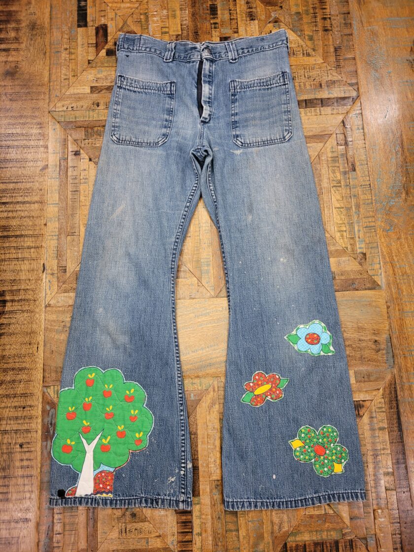 a pair of jeans with a tree on them.