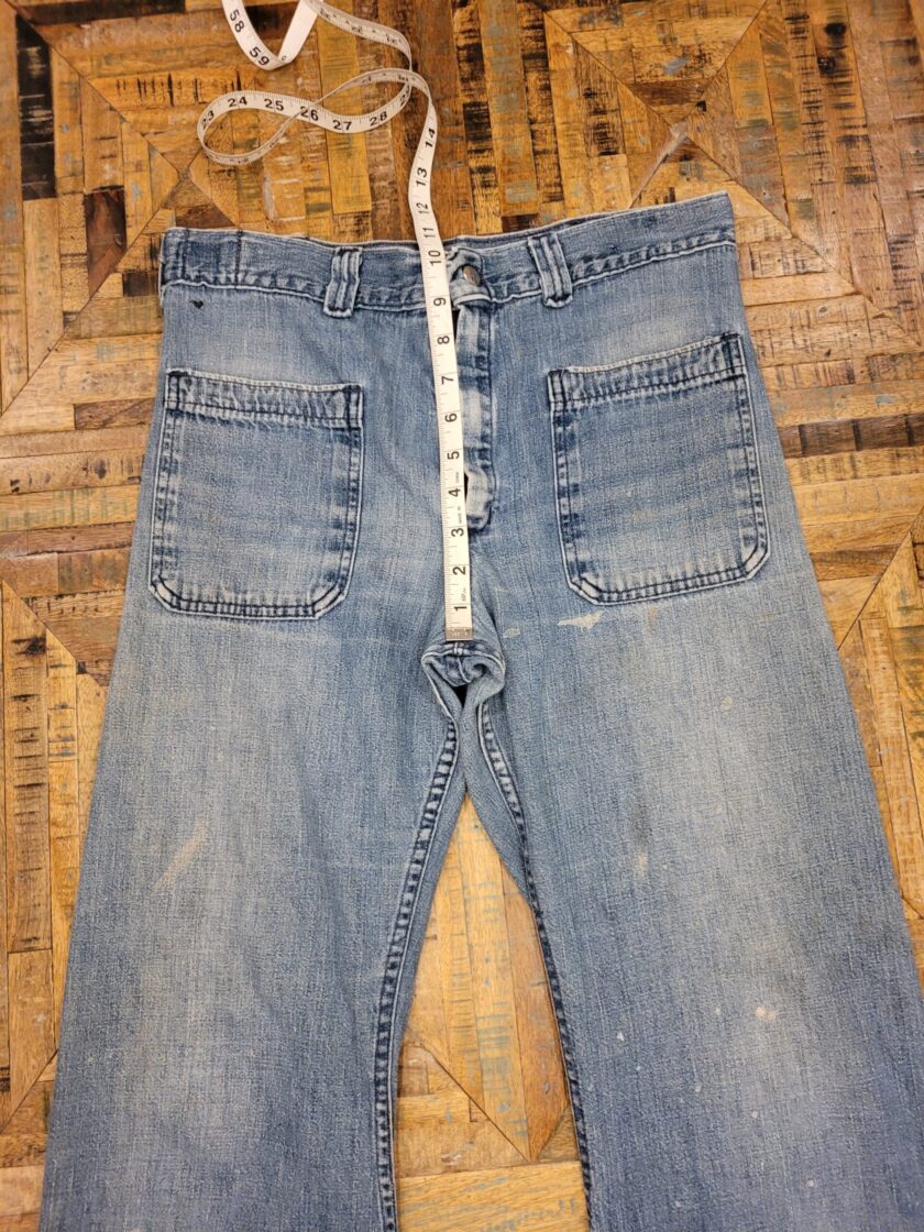 a pair of jeans with a tape measure on it.