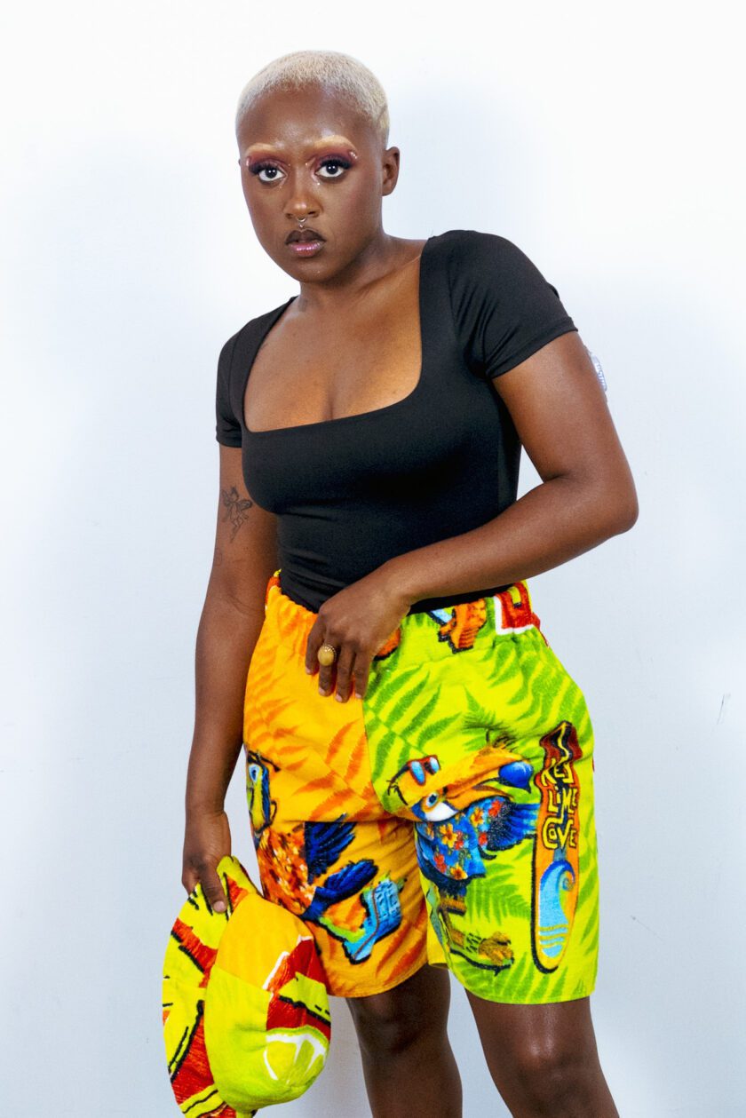 a woman in a colorful shorts posing for a photo.