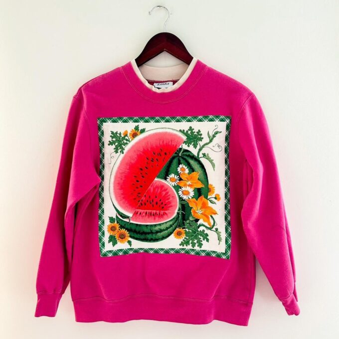 a pink sweatshirt with a watermelon on it.