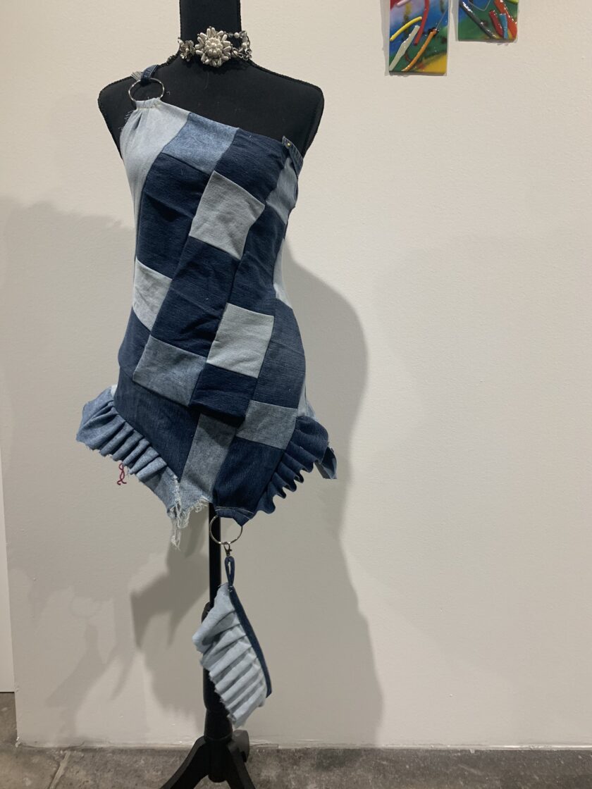 a mannequin with a blue and white dress on it.