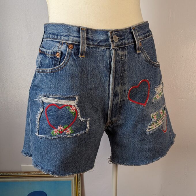 Reworked Upcycled vintage Levi's cutoff shorts with heart and floral patchwork and embroidery.