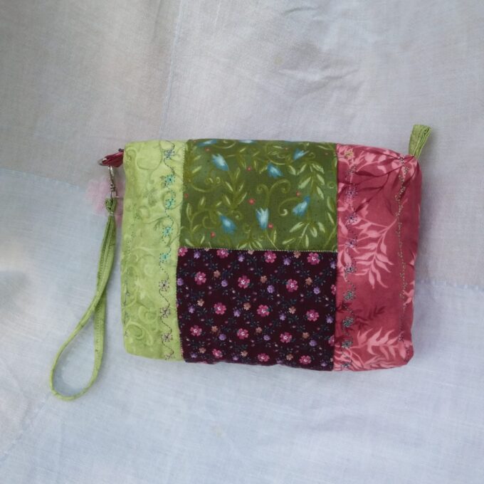 A small Cottage Core purse with a patchwork of vintage, upcycled fabrics.