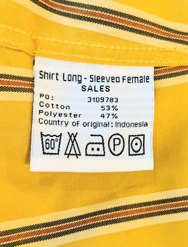 A label on a yellow shirt that says long sleeved female.