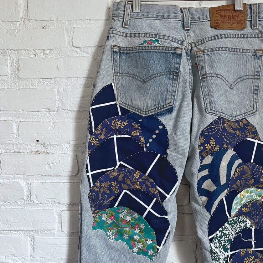 A pair of jeans with a patch on the back.