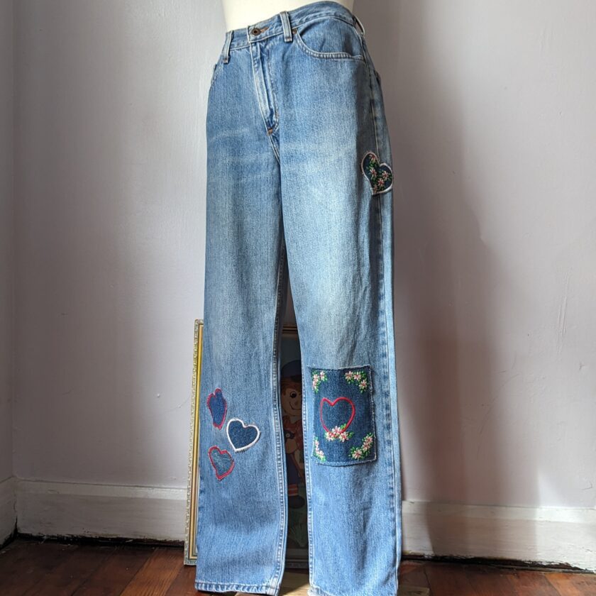 A mannequin wearing Embroidered Patchwork Heart Jeans by Sensible Slacks.