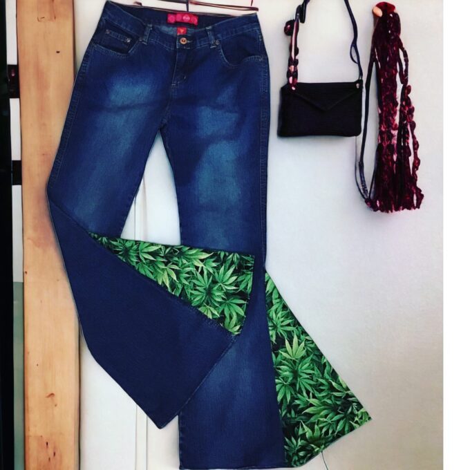 A pair of jeans with marijuana leaves on them.