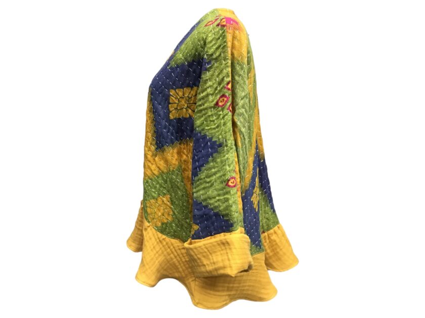 A yellow, blue and green sweater with a ruffled sleeve.