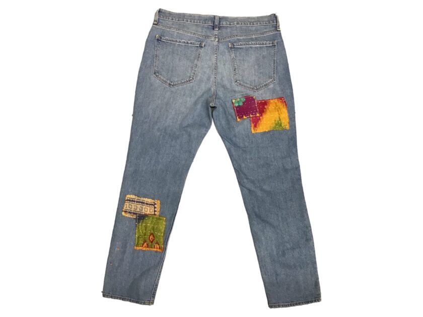 A pair of jeans with colorful patches on them.