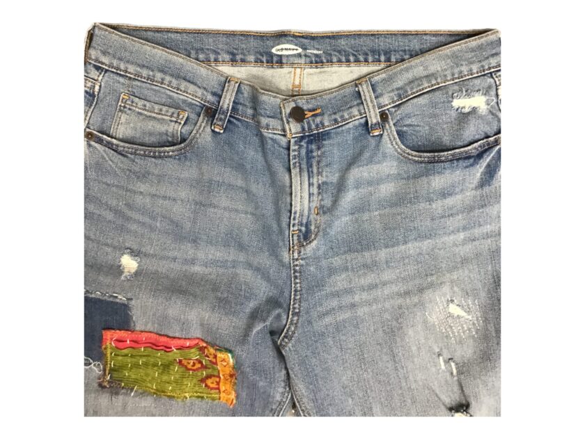 A pair of denim shorts with patches on them.
