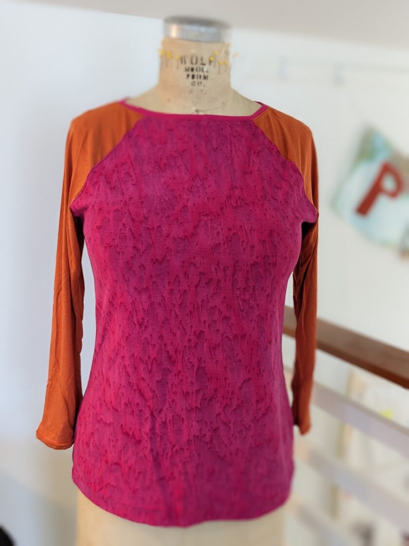 A mannequin with a pink and orange top.