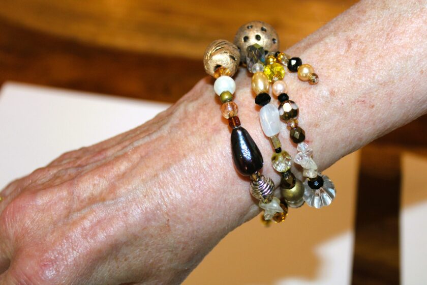 A woman's hand with a bracelet on it.