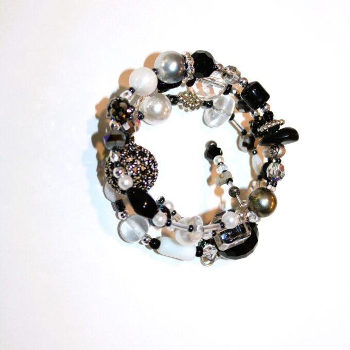 A black and white bracelet with beads and pearls.
