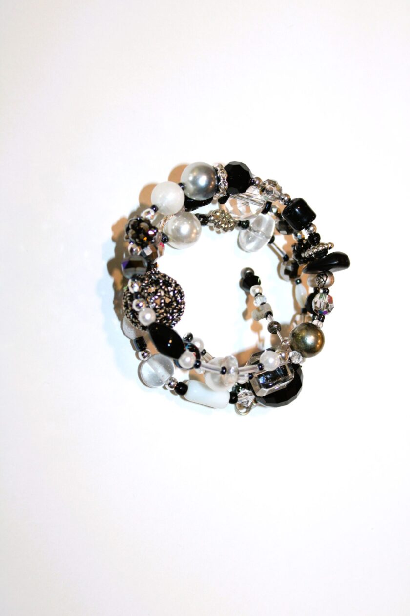 A black and white bracelet with beads and pearls.