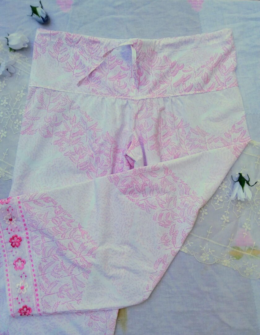 Elegant upcycled palazzo pants in pink and white, a floral design and vintage lace trim.