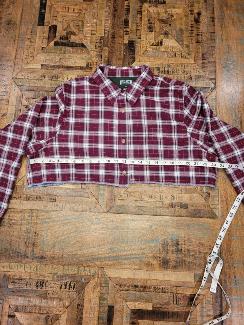 A plaid shirt with a measuring tape on it.