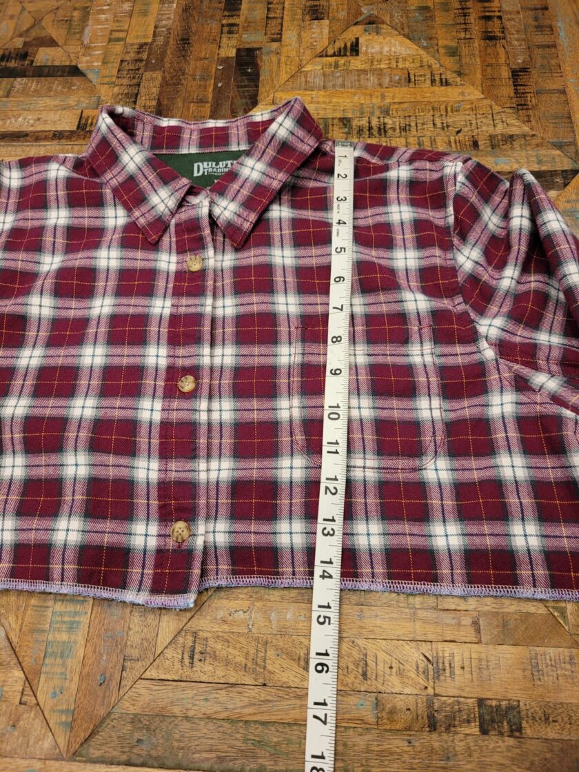 A red and white plaid shirt with a measuring tape.