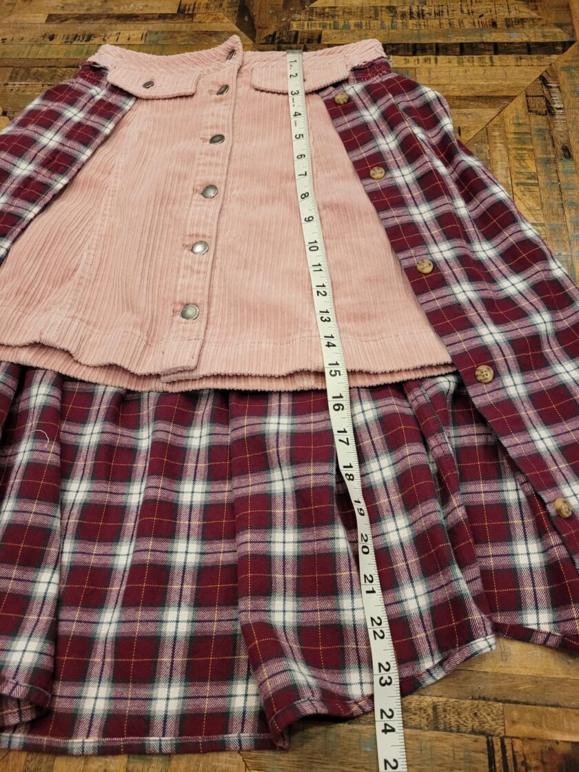 A pink and white plaid skirt with a measuring tape.