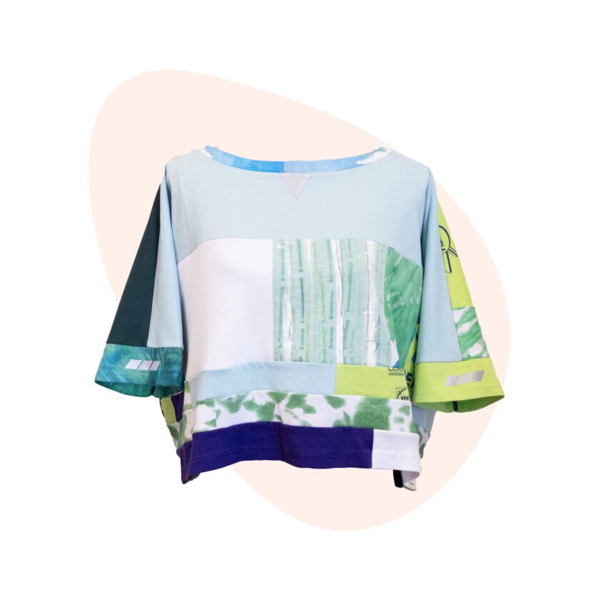 A t - shirt with a green, blue, and yellow pattern.