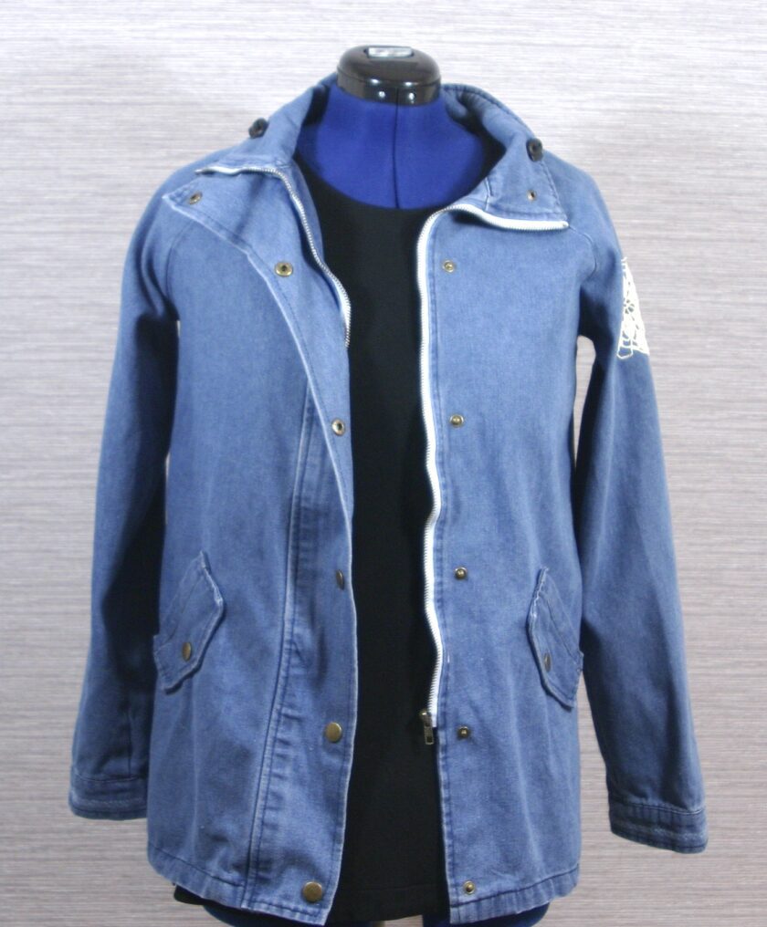 A blue denim jacket on a mannequin dummy.