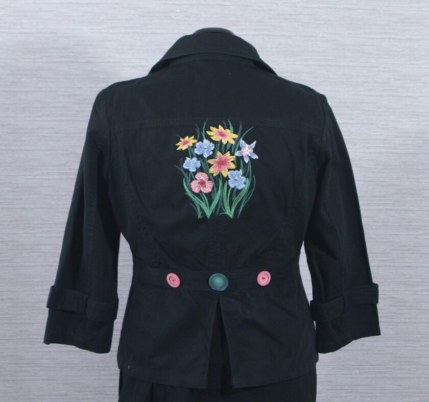 A black jacket with flowers embroidered on it.