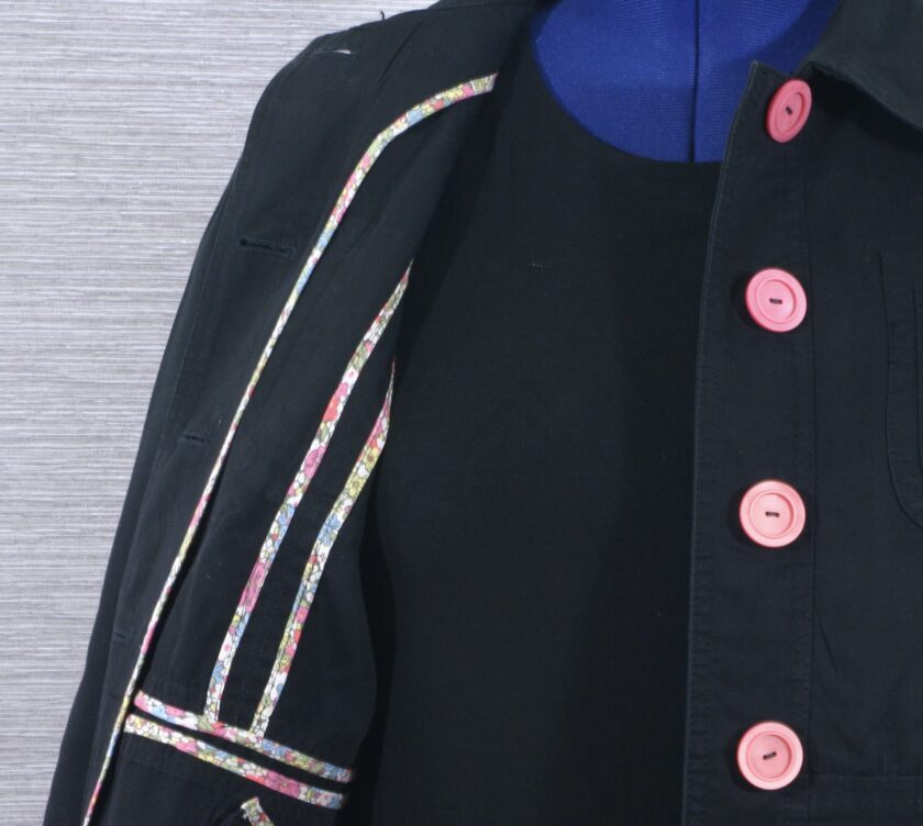 A black jacket with pink buttons.