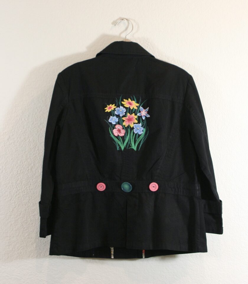 A black jacket with flowers embroidered on it.