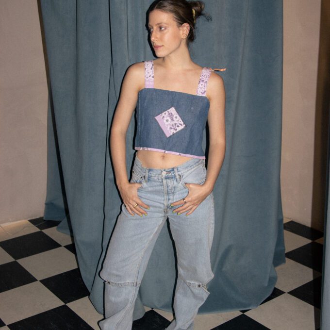 A woman standing in front of a checkered floor.