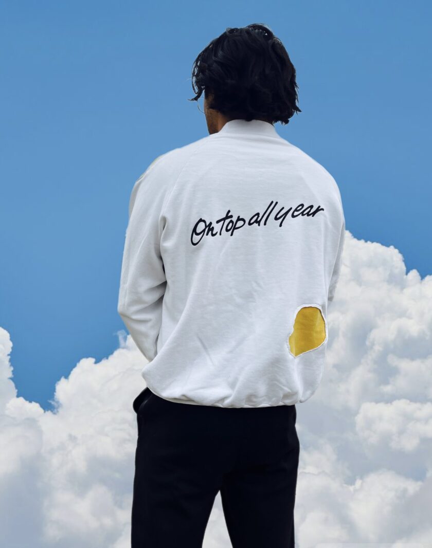 Model in front of clouds with sweatshirt cool style