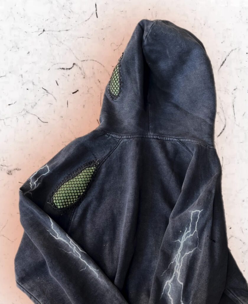 A black hoodie with lightning bolts on it.