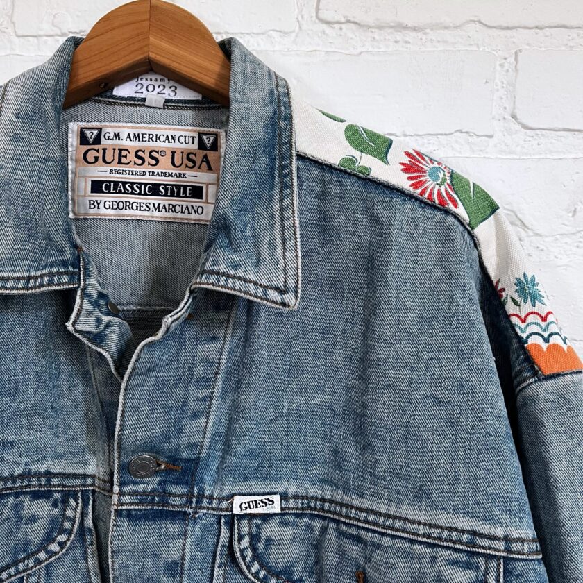 A denim jacket with a cactus on it.