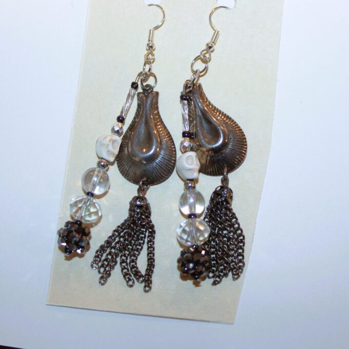 A pair of earrings with tassels hanging from them.